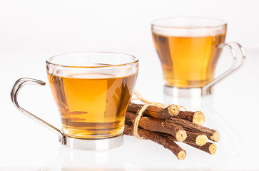 Tea and stems of licorice - Glycyrrhiza glabra. White background