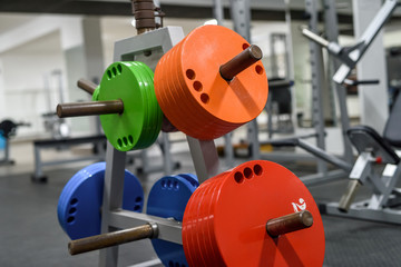 Different colour weights for barbells in gym