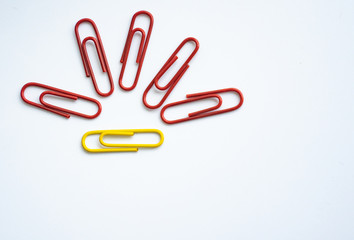 colored clips scattered on white background, form some pattern