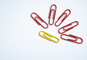 colored clips scattered on white background, form some pattern