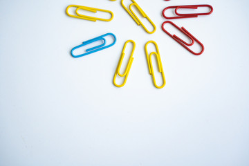 colored clips scattered on white background, form some pattern