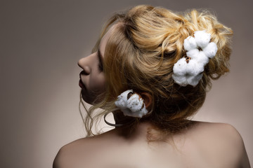 Professional promising model posing with cotton in her hairstyle