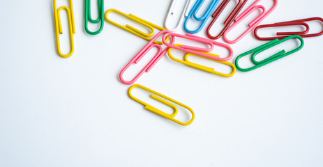 colored clips scattered randomly on white background