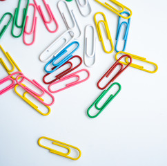 colored clips scattered randomly on white background