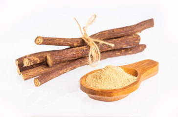Stems and licorice powder - Glycyrrhiza glabra. White background