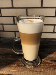 Delicious latte coffee on wooden table view 