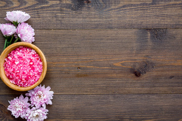 aroma therapy with pink flower fragrance and spa salt on wooden background top view space for text