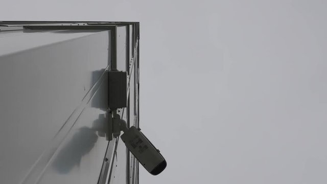 Outdoor Video surveillance and security camera monitoring in front of a modern business building. Outdoor CCTV system for commercial building footage