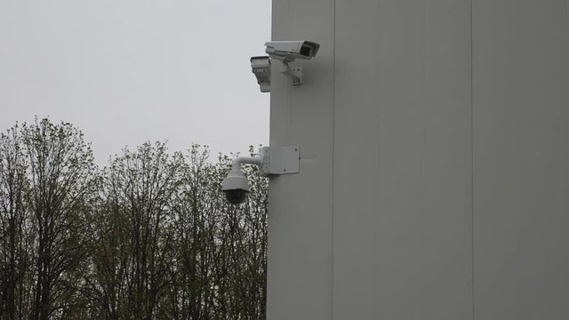 Outdoor video surveillance and security cameras installed on the corner business wall. CCTV system on commercial buildings