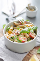 Salad - penne pasta with tomatoes, pesto, basil and lemon