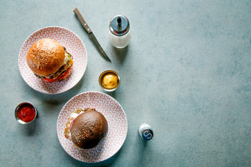 flat lay composition of Burger sauces and Cutlery on a grey surface with space for inscription
