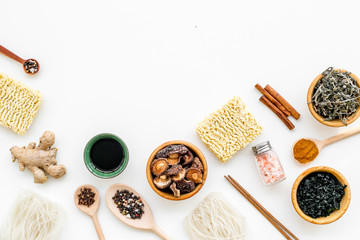 Chinese and Japanese food cooking with ginger, spices and noodles on white background top view mockup