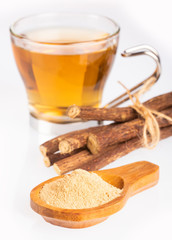 Licorice cup of tea, powder and roots - Glycyrrhiza glabra. White background