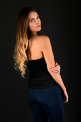 Naklejka premium Beautiful smiling woman with clean skin, natural make-up, and white teeth on grey background 
