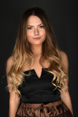 Naklejka premium Beautiful smiling woman with clean skin, natural make-up, and white teeth on grey background 