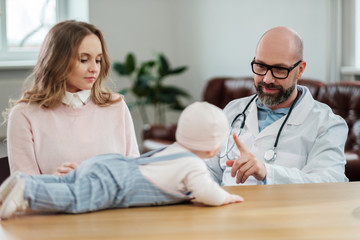 Fototapeta premium Mother with baby visiting pediatrician