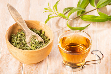 Tea with lemon verbena - Aloysia citrodora. Wood background