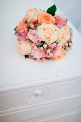 Bouquet from roses on vintage commode.