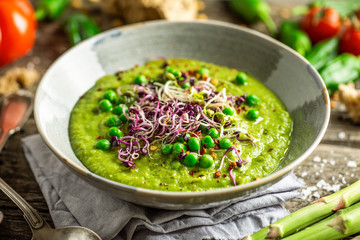 Healthy green pea soup served in bowl