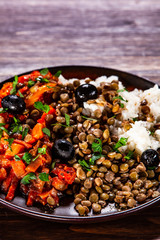 Rice with lentils and vegetables on wooden table