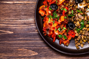 Rice with lentils and vegetables on wooden table