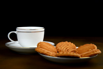cup of coffee and cookies on wooden table