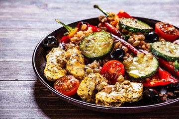 Pepper stuffed with groats and vegetables and grilled chicken strips