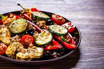 Pepper stuffed with groats and vegetables and grilled chicken strips