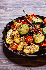 Pepper stuffed with groats and vegetables and grilled chicken strips