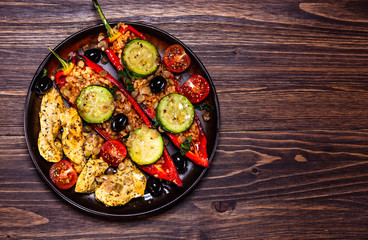 Pepper stuffed with groats and vegetables and grilled chicken strips