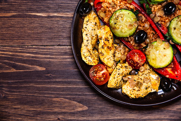 Pepper stuffed with groats and vegetables and grilled chicken strips