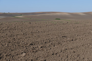 Fototapeta na wymiar Agricultural land. Treated spacious field in the plane. Ploughing time. Spring.