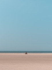 Fototapeta na wymiar Car parked on an empty beach