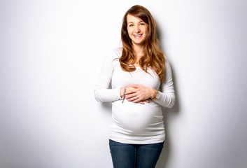 A Portrait of adorable pregnant woman in white