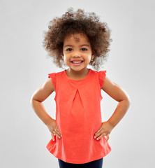 childhood and people concept - happy little african american girl over grey background