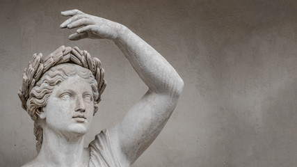 Fototapeta na wymiar Statue of sensual Roman renaissance era woman in circlet of bay leaves, Potsdam, Germany, details, closeup