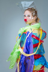 Model wrapped into non-natural material posing for ecology campaign