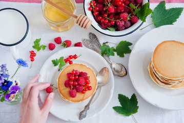 Breakfast Pancakes with fresh red berries and honey