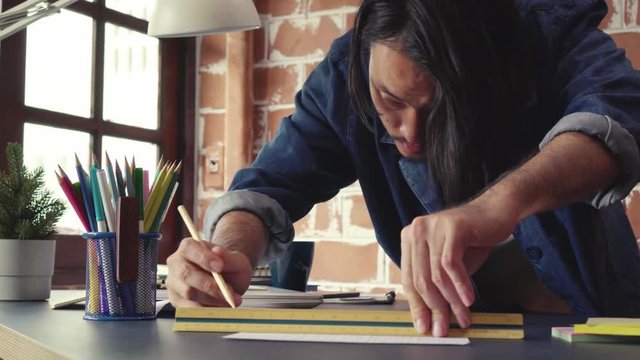 Young Asian man draft a drawing plan for artwork, architect, engineering drawing, creative designer concept