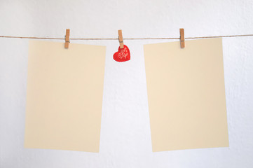 Hearts hang on clothespins on a white background..Nick with hearts hanging on it and empty...