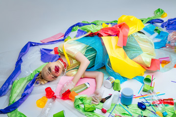 Model wrapped into plastic lying on floor near plastic