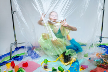 Model posing while surrounded by plastic harmful for the planet