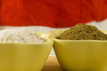 salt sea large granules ground coriander brown powder seasoning in green ceramic bowls macro design
