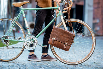 Man with retro bicycle and bag outdoors, cropped image with no face