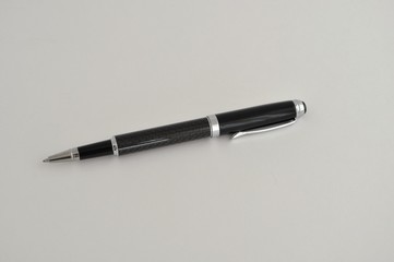 ballpoint pen with a cap on a light background