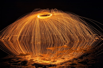 Light painting. Pyrotechnic display at night with the reflection of the water