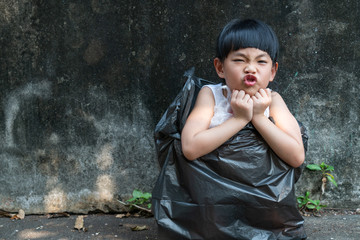 Little girl is acting in garbage bag