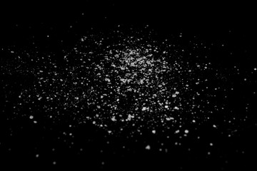 Fototapeta na wymiar white crystalline powder on a black background. sugar dust 