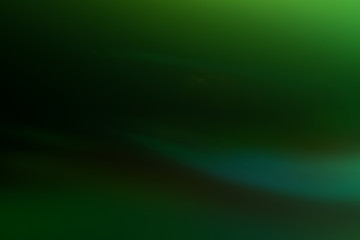 Smooth green color gradient. Glowing abstract black background. Lens flare effect.