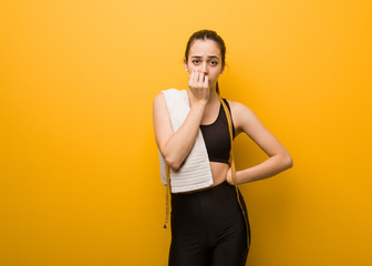 Young fitness girl biting nails, nervous and very anxious